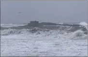  ?? MICHAEL P. NORTON / STATE HOUSE NEWS SERVICE ?? Waves pound the shoreline near Doctor’s Island, which is off the coast of Hull and Cohasset, on Wednesday afternoon, in a storm that knocked out power for many people in the area.