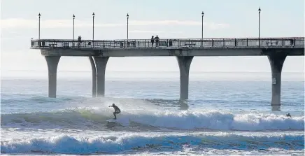  ?? Photo: Fairfax NZ ?? Several surfers were looking for waves at New Brighton beach after the overnight tsunami warning.