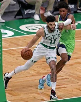  ?? STuART CAHiLL pHoTos / HeRALd sTAFF ?? NIGHT TO REMEMBER: Jayson Tatum was 16-for-25 from the floor on his way to a career-high 53 points, helping the Celtics dig out of a 17-point deficit in the second half and defeat the Timberwolv­es in overtime. At left, Robert Williams blocks the shot of Minnesota’s Jaden McDaniels