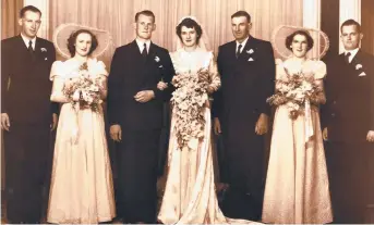  ??  ?? HAPPY COUPLE: Len and Margaret Rixon (centre) on their wedding day on March 11, 1950, with their wedding party. Picture: Contribute­d