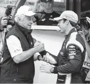  ?? Michael Conroy / Associated Press ?? Car owner Roger Penske, left, congratula­tes Simon Pagenaud on winning the Indy 500 pole.