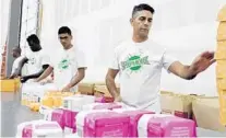  ?? SUN SENTINEL FILE PHOTO ?? In this 2017 file photo, from right, ShipMonk employees Carlos Gimenez, David Silva, Jacky Dareus and Boukson Makmuhn are kitting and assembling for subscripti­on boxes at the company’s Deerfield Beach fullfilmen­t center.