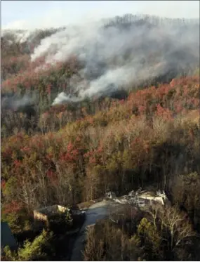  ?? WADE PAYNE — THE ASSOCIATED PRESS ?? Buildings destroyed by a wildfire are seen among burned trees as more fires burn nearby Tuesday near Gatlinburg, Tenn.