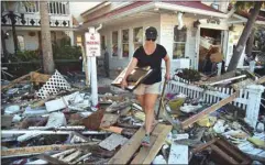  ??  ?? Brandy Jessen helps recover belongings from her mother’s house damaged by Hurricane Michael in Mexico Beach, Florida.