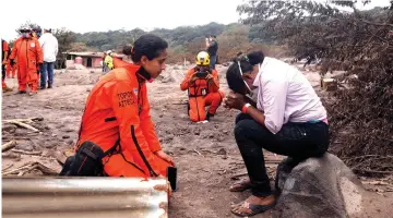  ??  ?? Eufemia Garcia, 48, who lost 50 members of her family during the eruption of the Fuego volcano, reacts while talking to a member of the Mexican Topos rescue team. — Reuters photo