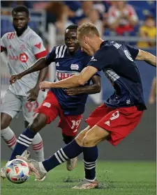  ?? MATT STONE / HERALD STAFF FILE ?? TWICE AS NICE: Adam Buksa, seen here against Toronto FC last season, had a pair of goals in the Revolution’s 2-2 tie with Atlanta United on Sunday.