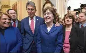  ?? J. SCOTT APPLEWHITE / ASSOCIATED PRESS ?? From left, a bipartisan group of U.S. senators celebrates a vote Monday to reopen the government: Sens. Susan Heitkamp, D-N.D.; Joe Donnelly, D-Ind.; Joe Manchin, D-W. Va.; Susan Collins, R-Maine; Amy Klobuchar, D-Minn.; and Doug Jones, D-Ala. The...