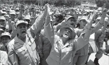  ?? RICARDO MAZALAN, THE ASSOCIATED PRESS ?? Militia members shouts slogans during a speech by the commander of the Venezuelan Bolivarian Militia, Gen. Carlos Leal Telleria, in Fort Tiuna, Caracas, Venezuela.