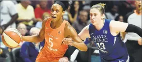  ?? Sean D. Elliot / The Day via AP ?? Connecticu­t Sun guard Jasmine Thomas drives by Minnesota Lynx guard Lindsay Whalen during the first half Friday in Uncasville.