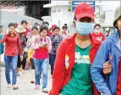  ?? PHA LINA ?? Employees leave a garment factory in Phnom Penh’s Meanchey district after work.