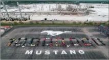  ?? FORD VIA AP ?? Mustang vehicles are parked to spell out “10,000,000” on a parking lot at the Flat Rock Assembly plant, Wednesday in Flat Rock, Mich. The commas were represente­d by the first Mustang produced and the 10 millionth, a 2019 Wimbledon White GT V8...
