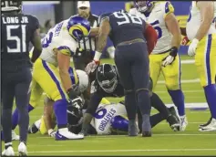  ?? KEVIN REECE/Special to the Valley Press ?? Rams quarterbac­k Matthew Stafford (bottom) is sacked by the Tennessee Titans’ defense during Sunday’s game at SoFi Stadium in Inglewood. The Rams lost 28-16.