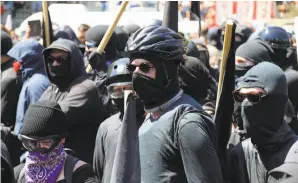  ?? Jim Wilson / New York Times ?? Masked antifa protesters dressed in black demonstrat­e at a Berkeley rally last week.