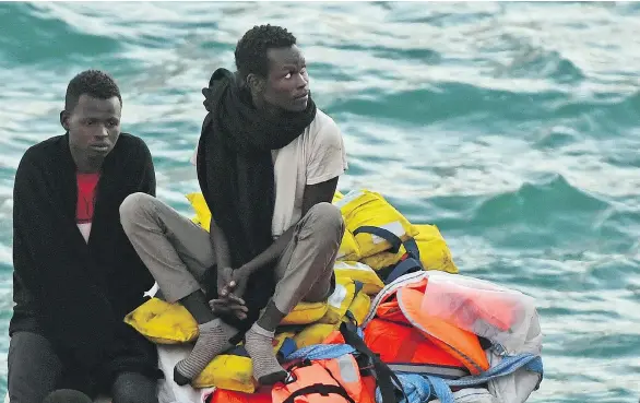  ?? JONATHAN BORG / THE ASSOCIATED PRESS ?? Migrants wait to disembark in Malta from a ship operated by a German aid group Wednesday after a journey of nearly a week while awaiting permission to make landfall.