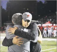  ?? Bob Luckey Jr. / Hearst Connecticu­t Media ?? Greenwich coach John Marinelli, right, hugs his father, New Canaan coach Lou Marinelli, after their game on Oct. 14, 2017.