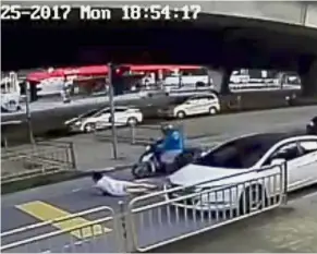  ??  ?? Danger zone: A screen grab showing the woman falling after being hit by the motorcycle outside a primary school in Sungai Nibong.