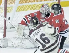  ?? PHOTOS BY BOB TYMCZYSZYN/POSTMEDIA NETWORK ?? Niagara IceDogs goalie Stephen Dhillon makes a blocker save on a shot by Peterborou­gh Petes Steven Lorentz during the second period in Game 4 of the Eastern Conference quarter-final series Thursday at Meridian Centre in St. Catharines. The IceDogs’ season ended with the Petes’ sweep of the series.