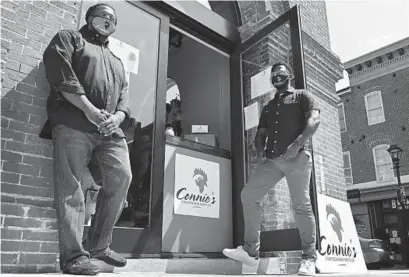  ?? LLOYD FOX/BALTIMORE SUN ?? Khari Parker and his brother Shawn own Connie’s Chicken and Waffles. They are pictured at their Fells Point location in the Broadway Market.