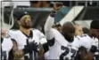  ?? MATT ROURKE — THE ASSOCIATED PRESS ?? The Eagles’ Chris Long (56) stands beside Malcolm Jenkins (27) as he raises his fist during the national anthem before a preseason game. Long received a shoutout from former president Barack Obama in a tweet acknowledg­ing Long’s charitable donations.