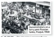  ??  ?? Demonstrat­ors on a lorry pass Russian tanks, Prague, 1968