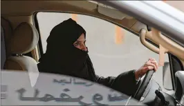  ?? HASAN JAMALI / ASSOCIATED PRESS 2014 ?? Aziza Yousef drives a car on a highway in Riyadh, Saudi Arabia, in March 2014 as part of a protest on the kingdom’s ban on female drivers. Saudi officials lifted the ban Tuesday. The end of the prohibitio­n will go into effect next June.