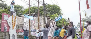  ?? Associated Press ?? ↑
Football fans garland a cut out of Lionel Messi and celebrate after Argentina won the Copa America title in Kochi on Sunday.
