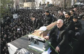  ?? Majid Saeedi / Getty Images ?? Mourners accompany the casket bearing the body of former Iranian President Akbar Hashemi Rafsanjani­i, a pivotal figure in the foundation of the Islamic republic in 1979.