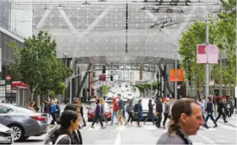  ??  ?? Left: The first above-ground structural
steel column being placed in 2014. Below:
Pedestrian­s cross Fremont Street in front
of the STC in 2019.
MARCH 2020
37