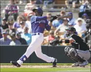  ?? Gregory Bull / Associated Press ?? Los Angeles Dodgers’ Mookie Betts, left, flies out as Chicago White Sox catcher Zack Collins, right, looks on during the first inning of a spring training game in Glendale, Ariz., on Feb. 24. Betts could become a free agent even if no games are played with the new MLB service deal.