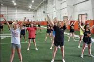  ?? Staff photo by Becky Bell ?? Texas High School cheerleade­rs work on their routines.