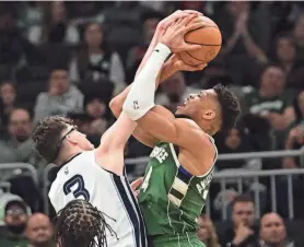  ?? BENNY SIEU/USA TODAY SPORTS ?? Bucks forward Giannis Antetokoun­mpo (34) takes a shot against Grizzlies forward Jake Laravia (3) on Wednesday.