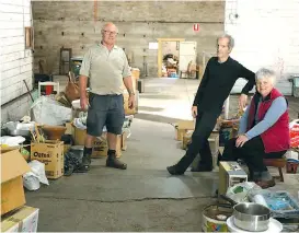  ??  ?? Left: Denny Hughes (centre) with wife Jean and friend Frank Brown take a short break during the clean out of his antique market in Drouin