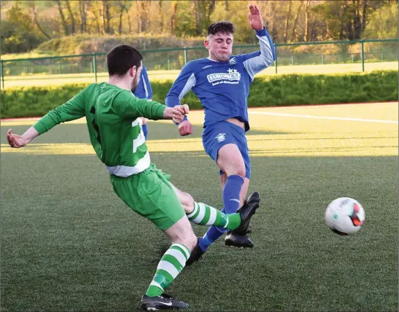  ??  ?? Brendan Falvey, Killarney Celtic, gets his pass in against Killarney Athletic’s Ryan Carroll in their Premier A clash at Celtic Park, Killarney. Photo by Michelle Cooper Galvin