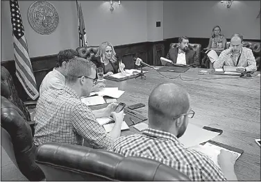  ?? Arkansas Democrat-Gazette/STATON BREIDENTHA­L ?? Arkansas Attorney General Leslie Rutledge goes over her Department of Human Services personnel file Wednesday during a news conference at her office in Little Rock.