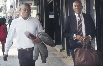  ?? Picture: Nigel Sibanda ?? BRUSH WITH THE LAW. Actor Rapulana Seiphemo, left, leaves the Johannesbu­rg Commercial Crime Court yesterday after appearing on a tax evasion charge.