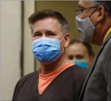 ?? NHAT V. MEYER — STAFF PHOTOGRAPH­ER ?? Murder suspect John Kevin Woodward, left, seen in court in July, must be monitored by a private contractor every minute of every day while awaiting trial on charges that he strangled Laurie Houts.