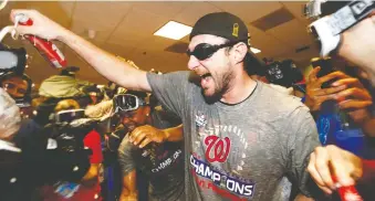  ?? ELSA/GETTY IMAGES ?? The Nationals’ Max Scherzer celebrates in the locker-room after Washington beat the Astros in Game 7 to win the World Series on Thursday in Houston. The starting pitcher battled through five innings.