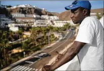  ?? RENATA BRITO/ASSOCIATED PRESS ?? Senegalese migrant Fode Top looks at the view from the hotel room at Holiday Club Puerto Calma in Puerto Rico de Gran Canaria, Spain. Top, a 28-year-old fisherman, left his country in November in search of better work in Europe.