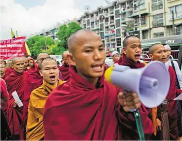  ?? AP ?? Vocal group Myanmar’s nationalis­t Buddhist monks shout slogans during a protest rally in Yangon yesterday. Protesters marched through Yangon’s streets over the boat people issue.