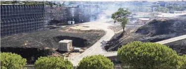  ?? ?? Smoke billows from scorched earth after a fire erupted at the Cinecitta studios southeast of Rome.