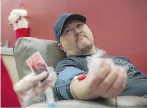  ?? SHAUGHN BUTTS ?? Kevin Cornish of Weyburn, Sask., gives blood in Edmonton while his seven-month-old son recovers from heart surgery.