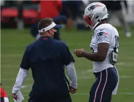  ??  ?? GETTING ON SAME PAGE: Offensive coordinato­r Josh McDaniels talks with wide receiver N'Keal Harry during practice at Gillette Stadium on Wednesday.