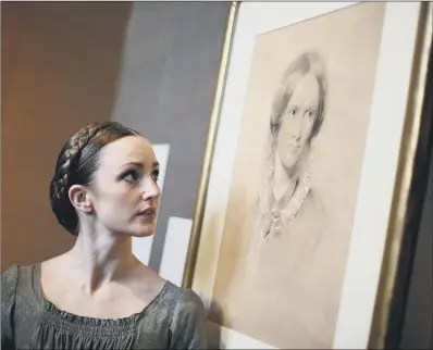  ?? PICTURE: YUI MOK/PA WIRE. ?? LIFE PORTRAIT: Northern Ballet leading dancer Hannah Bateman beside a chalk sketch of author Charlotte Brontë.