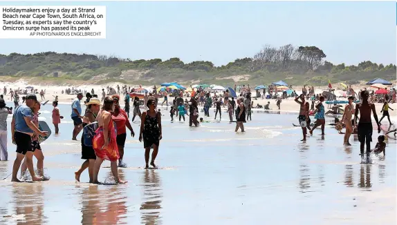  ?? AP PHOTO/NARDUS ENGELBRECH­T ?? Holidaymak­ers enjoy a day at Strand Beach near Cape Town, South Africa, on Tuesday, as experts say the country’s Omicron surge has passed its peak