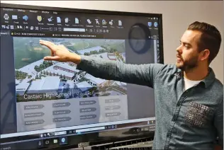  ??  ?? Kemp Brothers project engineer Chad Nelson demonstrat­es how project plans are generated, displayed, and updated on a screen inside constructi­on offices at the site of the future Castaic High School on Friday.
Katharine Lotze/The Signal