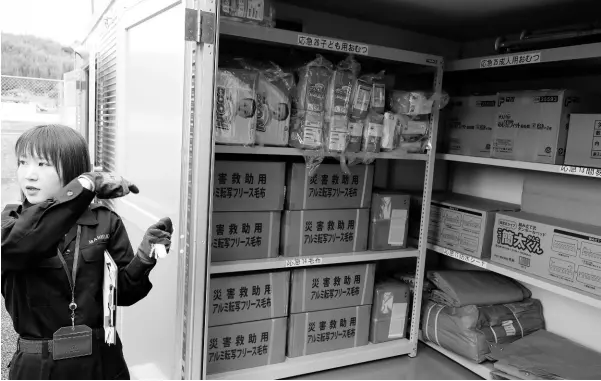  ?? PHOTO BY CHRISTOPHE­R SERJU ?? Madoka Kusano points to some of the supplies in the locker.