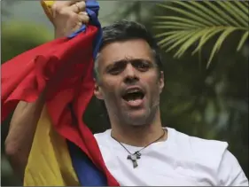 ??  ?? In this July 8, file photo, Venezuela’s opposition leader Leopoldo Lopez holds a national flag as he greets supporters outside his home in Caracas, Venezuela, following his release from prison and being placed under house arrest after more than three...