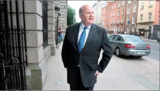  ??  ?? High noon for Finance Minister Michael Noonan.