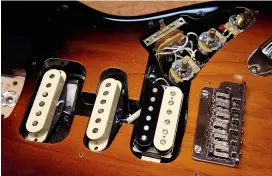  ??  ?? Now we’ve got our lovely new guard ready to go, let’s strip down the old 8 one. Loosen off all the parts from the old pickguard and stash all the small screws. Make sure they do not find a way to get stuck to a pickup, as they will break it given half a chance.