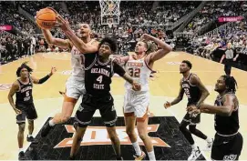  ?? Charlie Riedel/Associated Press ?? Forward Dylan Disu (1) and Texas shook off a slow start to race past Oklahoma State for a 60-47 win and advance to the Big 12 tournament semifinals.